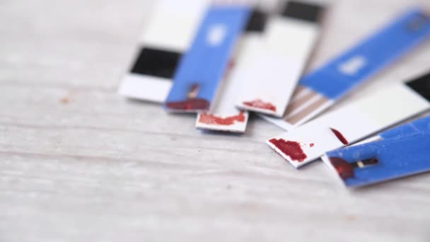 Close up of used diabetic strips on white background — Stockvideo