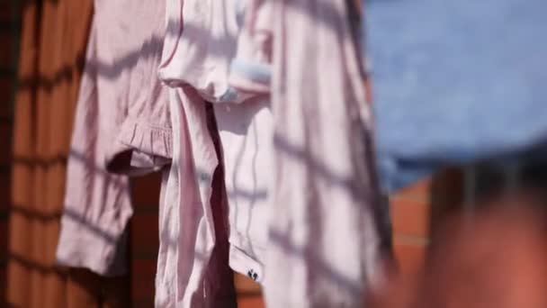 Παιδικά ρούχα γραμμή γεμάτη με κρεμασμένα παντελόνια — Αρχείο Βίντεο