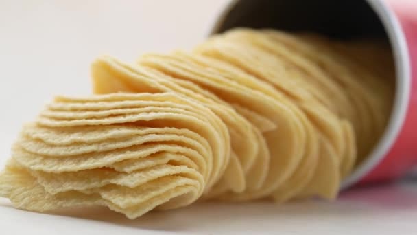 Close up of chips spilling on white background — Stock Video