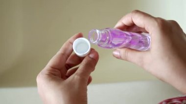 rear view of women using mouth wash 