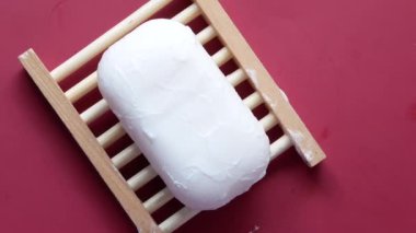 Soap and bubbles on a case on red background 