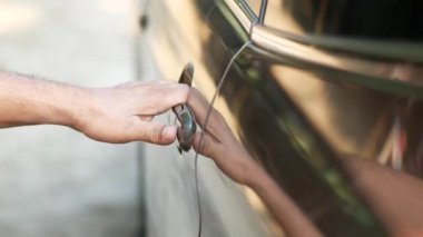 men hand open a car door 