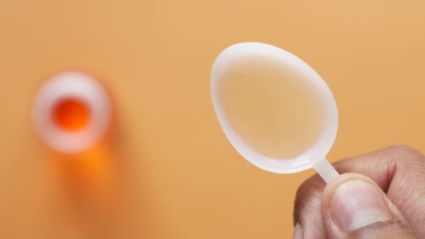 Liquid medicine on a plastic spoon — Αρχείο Βίντεο