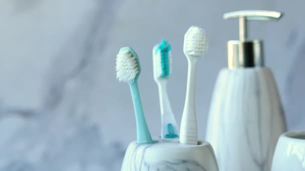 Toothbrushes in white mug and soap on tiles background — Video Stock