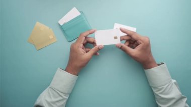 top view of man holding many credit card 