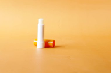  moisturising lip balm on orange background 