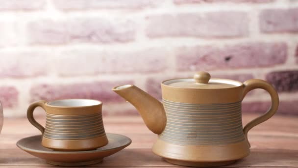 Tea cup and alarm clock on table — Video