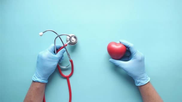 Top view of doctor hand using stethoscope and hear shape symbol — Stockvideo