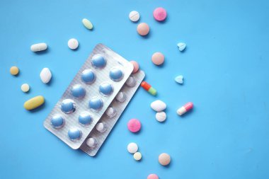 top view of pills of blister pack on blue background 