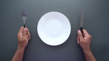 Siyah arka planda boş tabak taşıyan adamlar. 