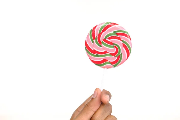 Holding lollipop candy isolated on white — Stock Photo, Image