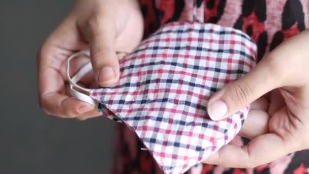 Vrouwen hand houden zelfgemaakt gezicht masker, close up — Stockvideo