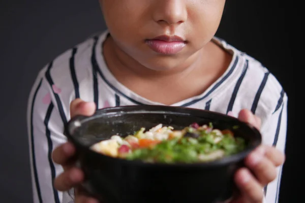 Child girl holding a bowl of salad — Stock Photo, Image