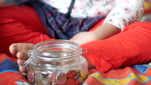 Child girl pile coin for saving. sitting on floor — Vídeo de Stock