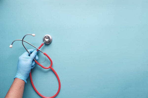 top view of doctor hand using stethoscope.