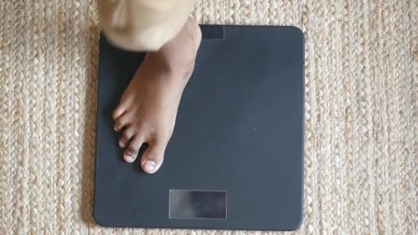 Молодые люди ноги на весовой шкале вид сверху — стоковое видео