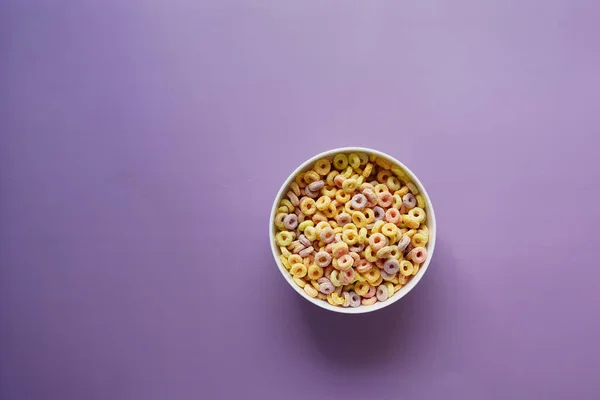 Top view of colorful cereal corn flakes in a bowl — Stock Photo, Image