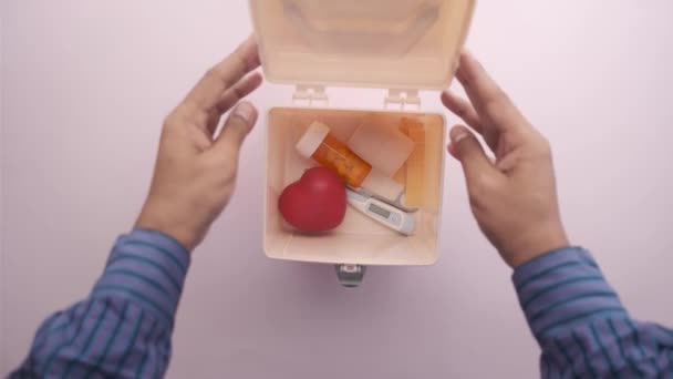 Hombre abrir una caja de botiquín de primeros auxilios y recoger medicina — Vídeo de stock