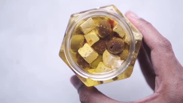 Cubo de queijo, azeitona e ervas em um recipiente — Vídeo de Stock