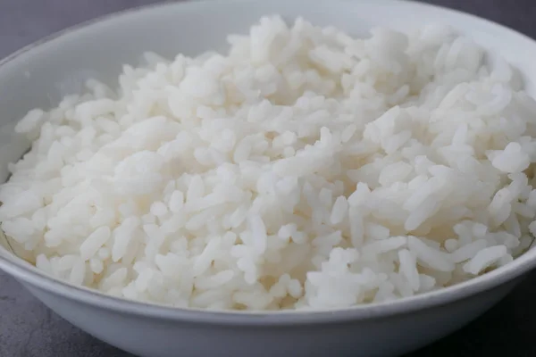 Cooked rice in a bowl on table, close up, — Stock Photo, Image