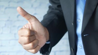 Erkek eli baş parmağını kaldırıyor. 