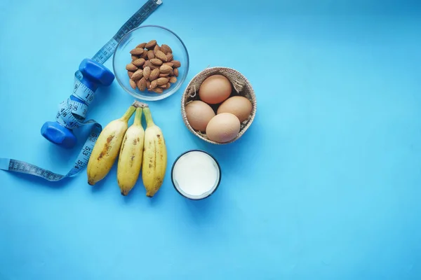 Eggs in a bowl, milk and almond nut in table — Stock Photo, Image