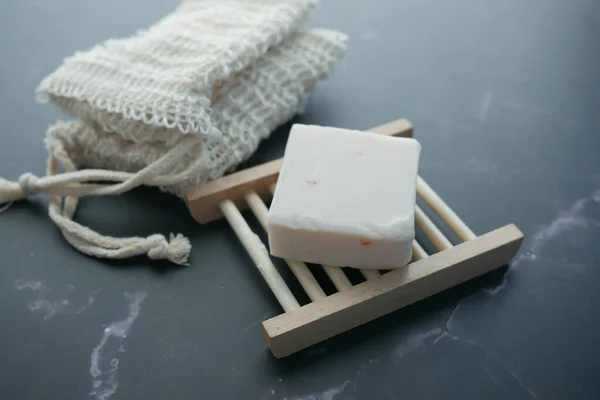 Homemade natural soap bar on black background — Stock Photo, Image