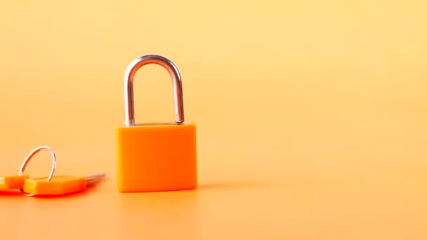 Orange color Padlock And Key on table — Stock Video