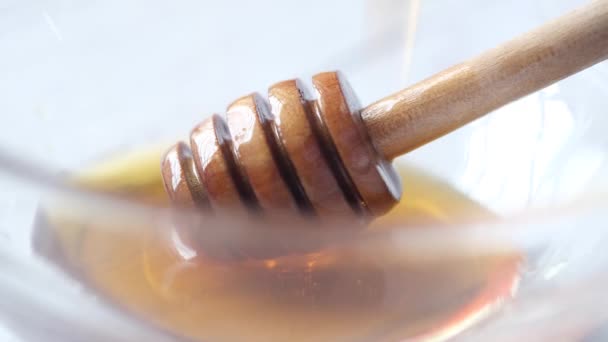 Close up of fresh honey with spoon on table — стоковое видео