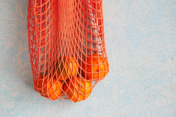 Fruta naranja fresca en una bolsa de compras en la mesa — Foto de Stock