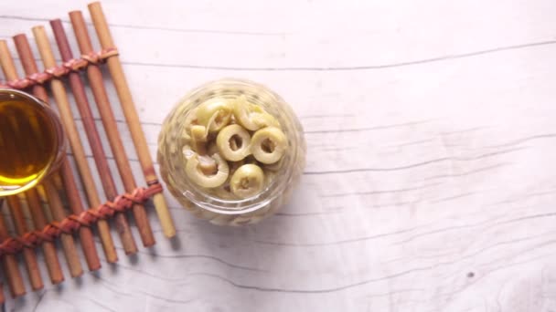 Bottle of olive oil and fresh olive in a container on table . — Stock Video