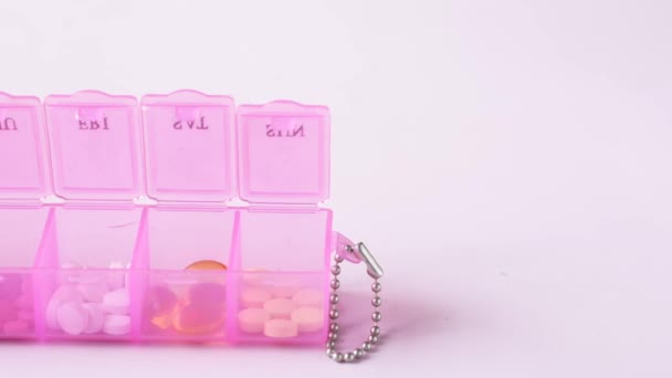 Top view of medical pill box on color background — Stock Video