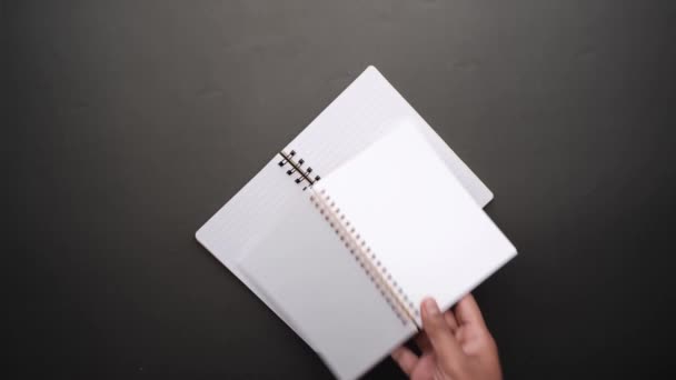 High angle view of open notepads on back background — Stock Video