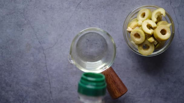 Bottle of olive oil and fresh olive in a container on table . — Stock Video