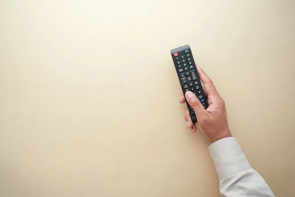 Top view of man hand holding tv remote. — Stock Photo, Image