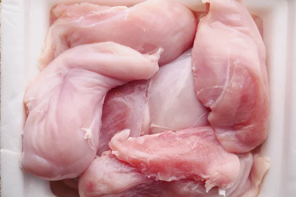 Surowe piersi kurczaka w opakowaniu na stole — Zdjęcie stockowe