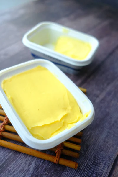 白を基調としたパンの入った容器の中の生バター — ストック写真