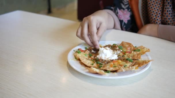 Kvinnor äter majschips nachos med stekt malet kött — Stockvideo