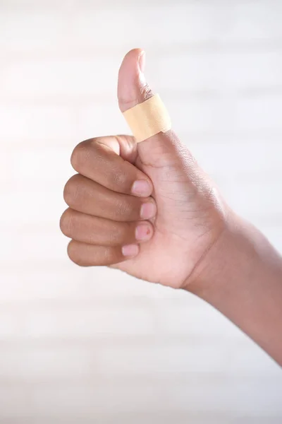 Thumb finger with adhesive bandage wrapped around . — Foto Stock