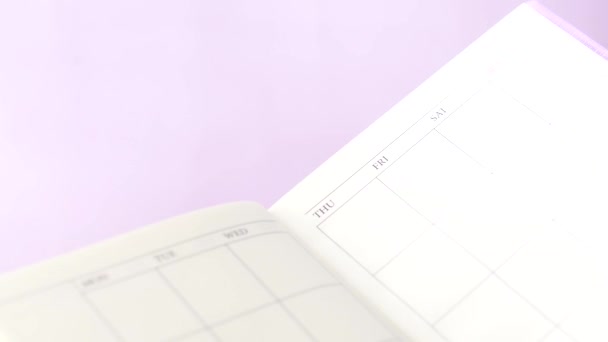 Turning pages of a weekly planner — Stok video