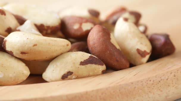 Brazilian nut in a bowl on wooden background — Αρχείο Βίντεο