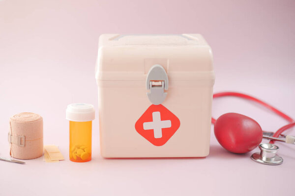 first aid kit box and medicine on table 