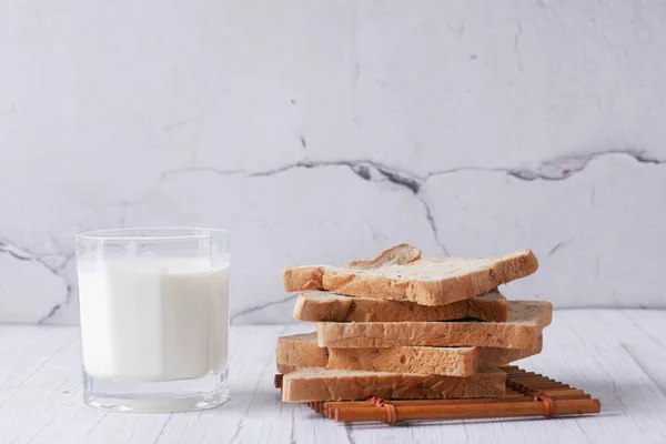 Glass of milk and white bread on table — Stockfoto