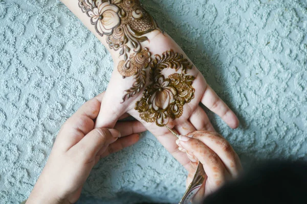 Mulheres aplicando henna na mão — Fotografia de Stock