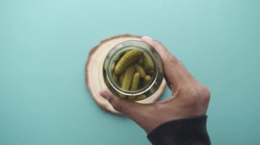  bottle of pickled cucumbers, pickles on table .