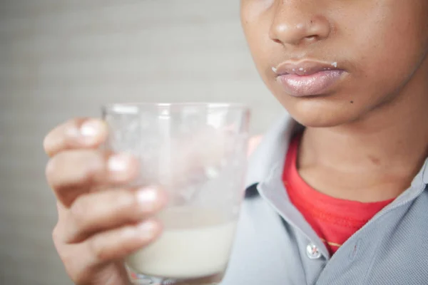 Teenage Boy Drinking Milk While Sited — Stock Photo, Image