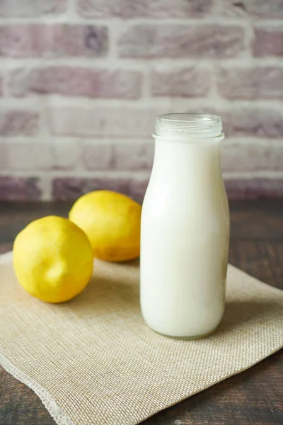 milk jar and lemon on table
