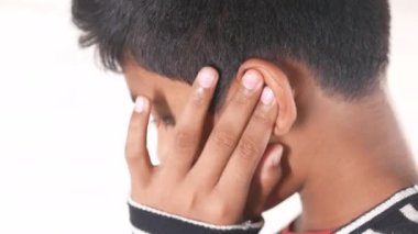 teenage boy having ear pain touching his painful ear 