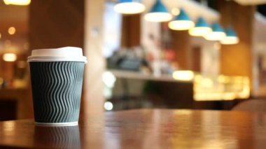 take away paper coffee cup o on cafe table ,