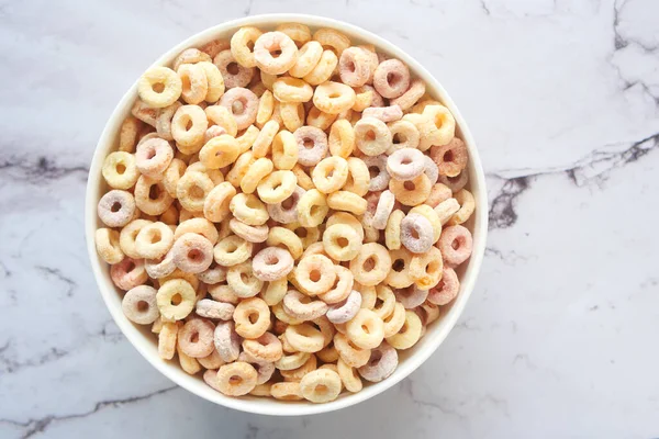 close up of colorful cereal corn flakes in a bowl .